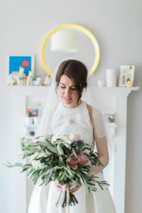 bright photo of a bride holding a bouquet