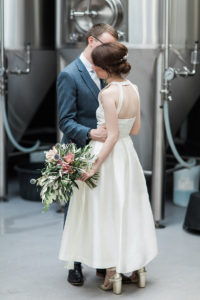 a bride and groom inside the brewery